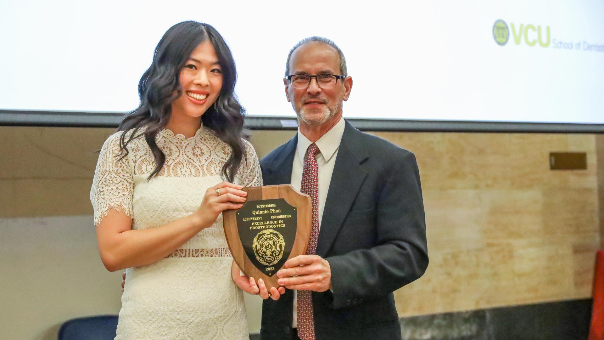 Phan photographed with Dr. Healy after receiving the Excellence in Prosthodontics award at the 2023 senior awards ceremony.