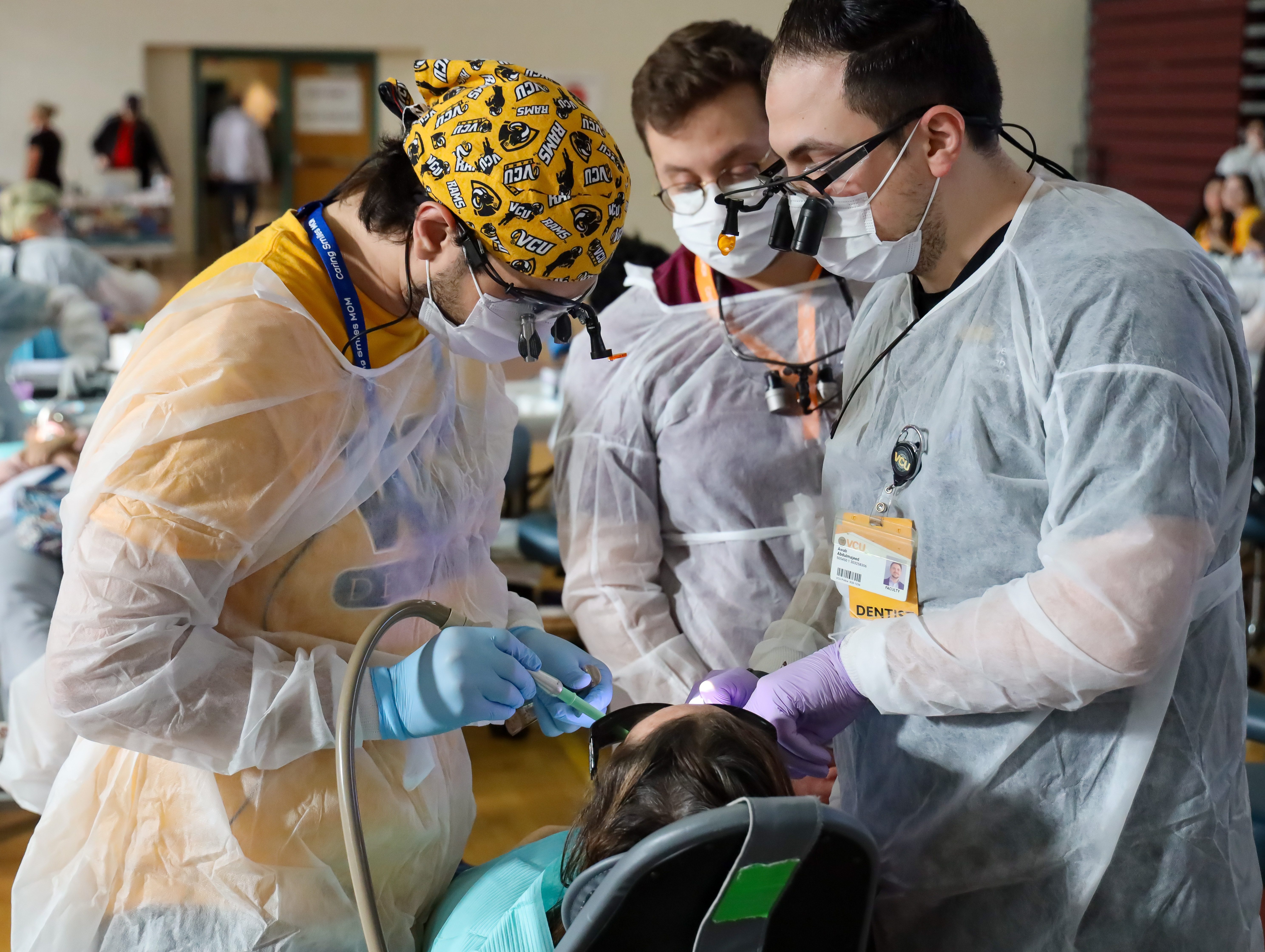 Ahmad Elmotaseb and School of Dentistry faculty member Dr. Awab Abdulmajeed work on patient during Suffolk MoM project in March of 2024.