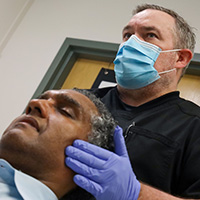 Thumbnail-sized image of Dr. Shawn McMahon examining a patient