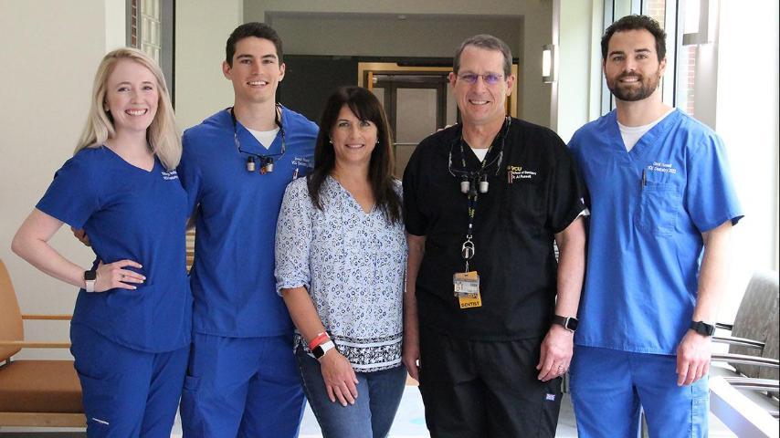 From left to right: Katie Veltman stands with Joey, Cris, Al and David Russell.